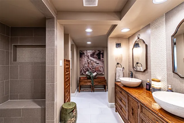 a bathroom with a double vanity sink and a mirror