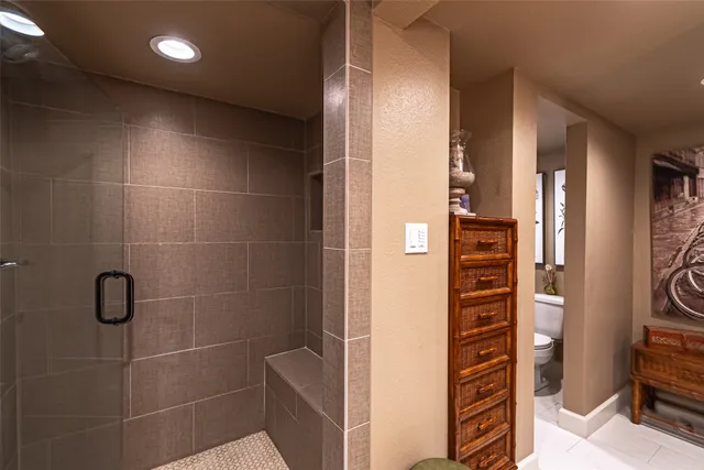 a bathroom with a double vanity sink a mirror and shower