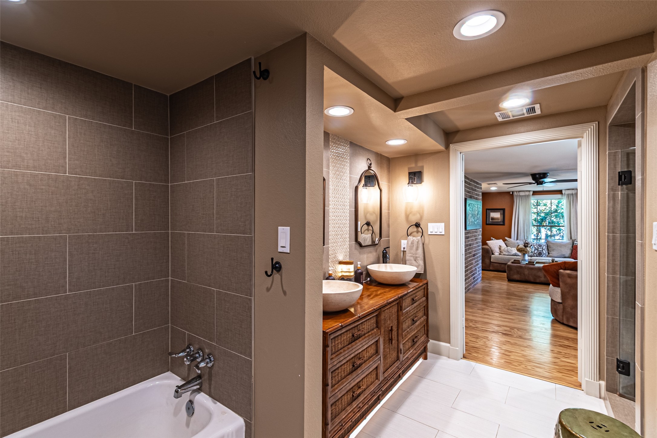 706 Church Street Navasota, TX 77868 - Photo 37 of 50 a bathroom with a double vanity sink a mirror and shower