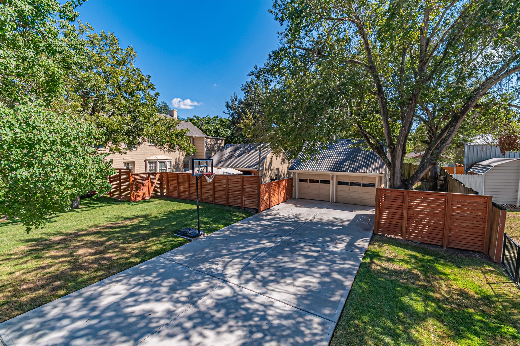 706 Church Street Navasota, TX 77868 - Photo 4 of 50 a view of a backyard with wooden fence and large trees