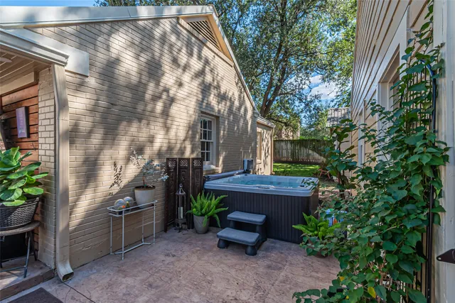 a patio with a table and chairs under an umbrella