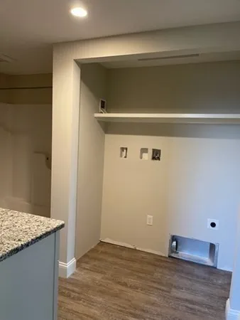 a bathroom with a granite countertop sink and a toilet