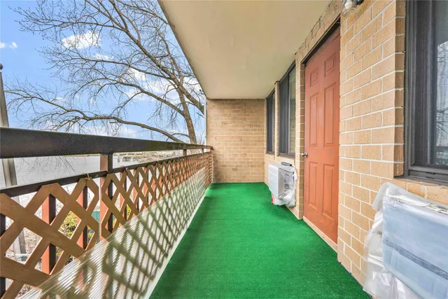 a view of a balcony next to a yard