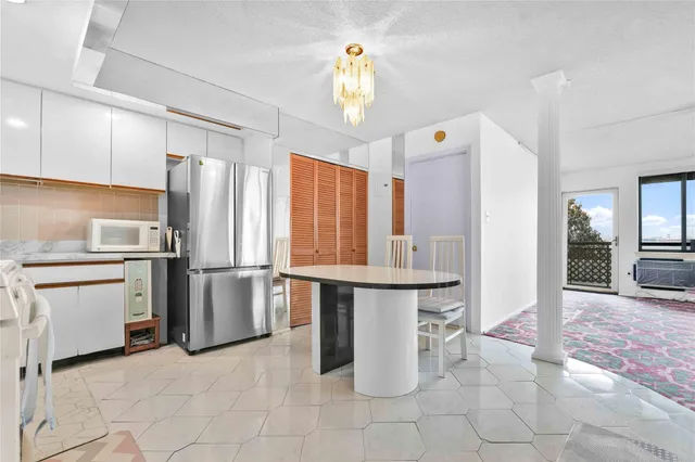 a kitchen with refrigerator and cabinets