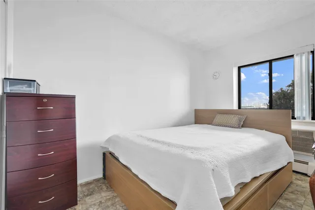 a bedroom with a bed and a large mirror