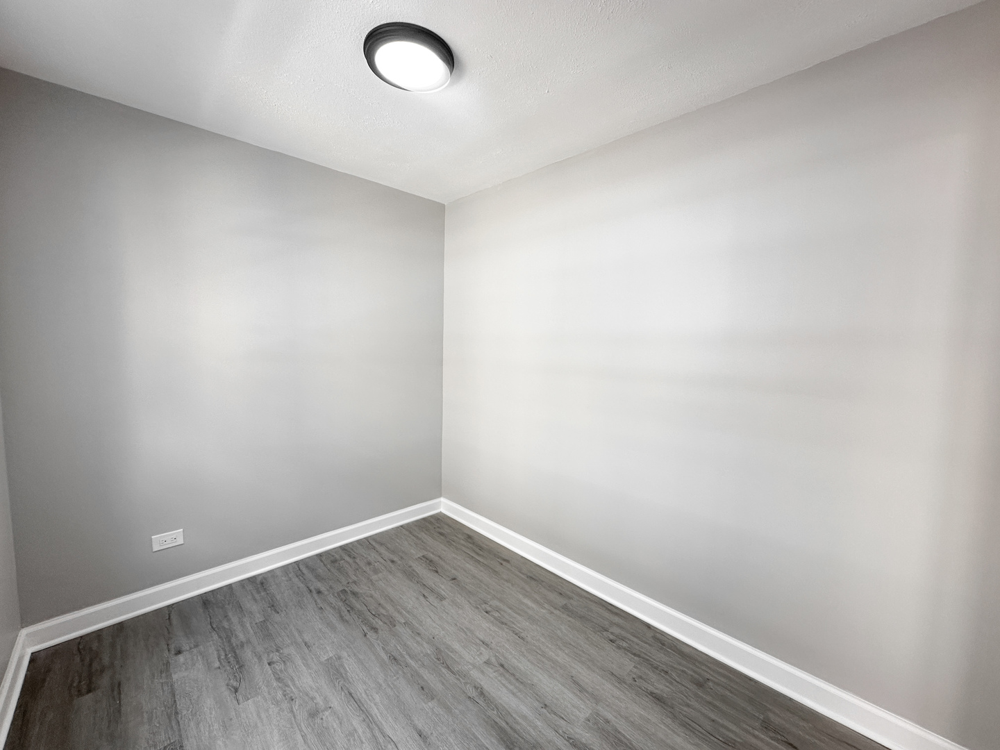 4300 North Keystone Avenue, Unit 3C Chicago, IL 60641 - Photo 9 of 10 a view of an empty room with wooden floor