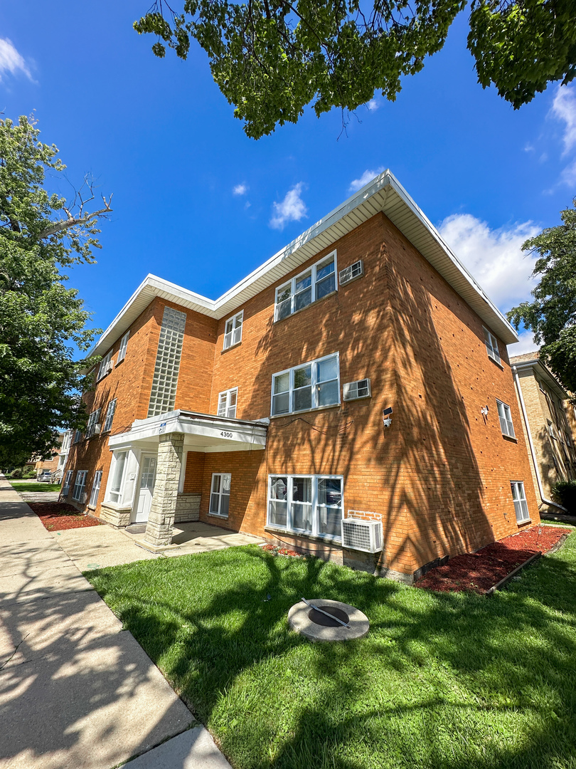 4300 North Keystone Avenue, Unit 3C Chicago, IL 60641 - Photo 10 of 10 a view of a house with a yard