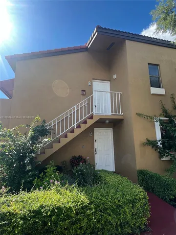 a view of balcony with potted plants and wooden wall