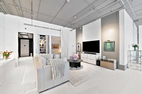 a bedroom with furniture and a flat screen tv