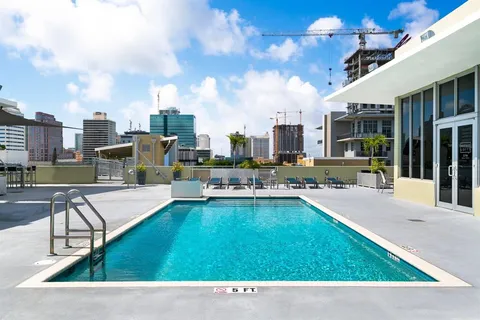 a swimming pool with outdoor seating and yard