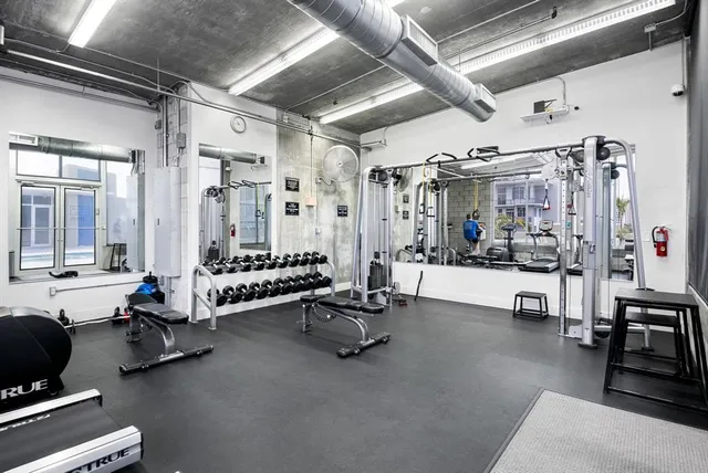 a living room with patio furniture and a chandelier
