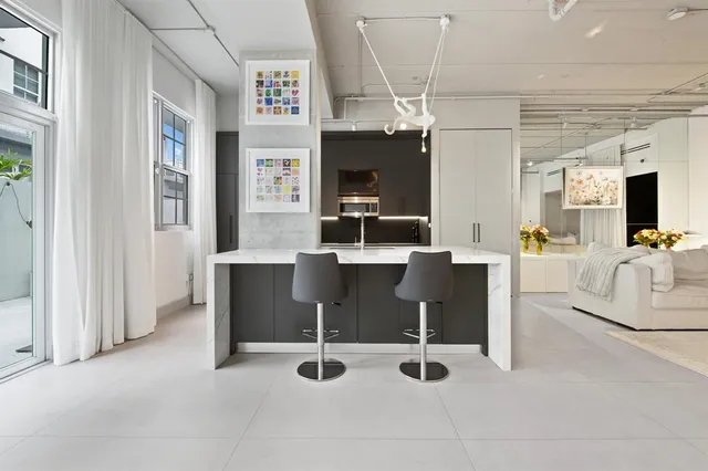 a view of a livingroom with furniture and a flat screen tv