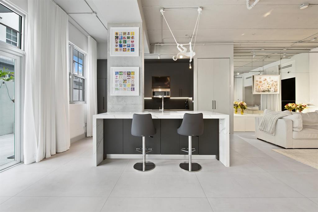 425 North Andrews Avenue, Unit 206 Fort Lauderdale, FL 33301 - Photo 5 of 17 a view of a livingroom with furniture and a flat screen tv