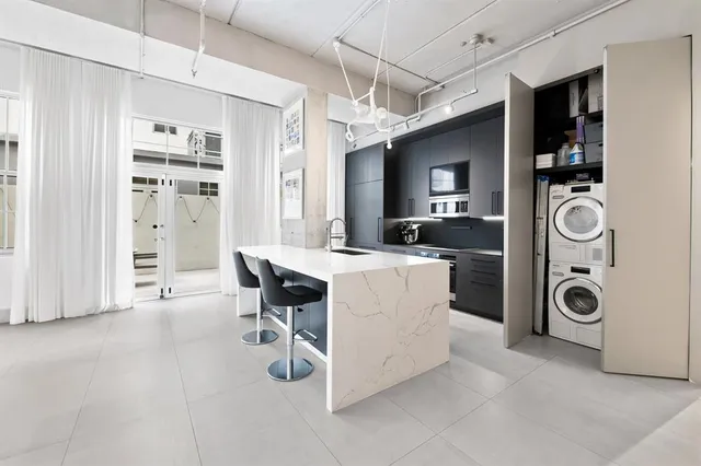 a view of kitchen with sink microwave and refrigerator
