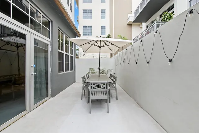 a roof deck with table and chairs