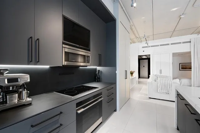a kitchen with stainless steel appliances a stove microwave and a refrigerator