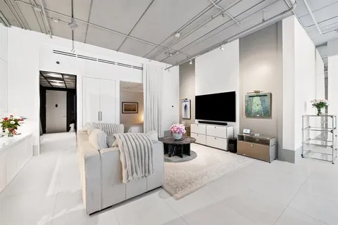 a bedroom with furniture and a flat screen tv