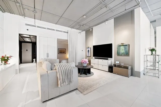 a bedroom with furniture and a flat screen tv