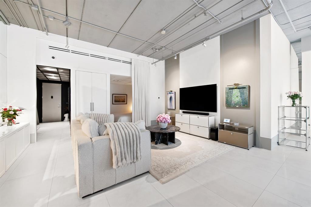 425 North Andrews Avenue, Unit 206 Fort Lauderdale, FL 33301 - Photo 10 of 17 a bedroom with furniture and a flat screen tv