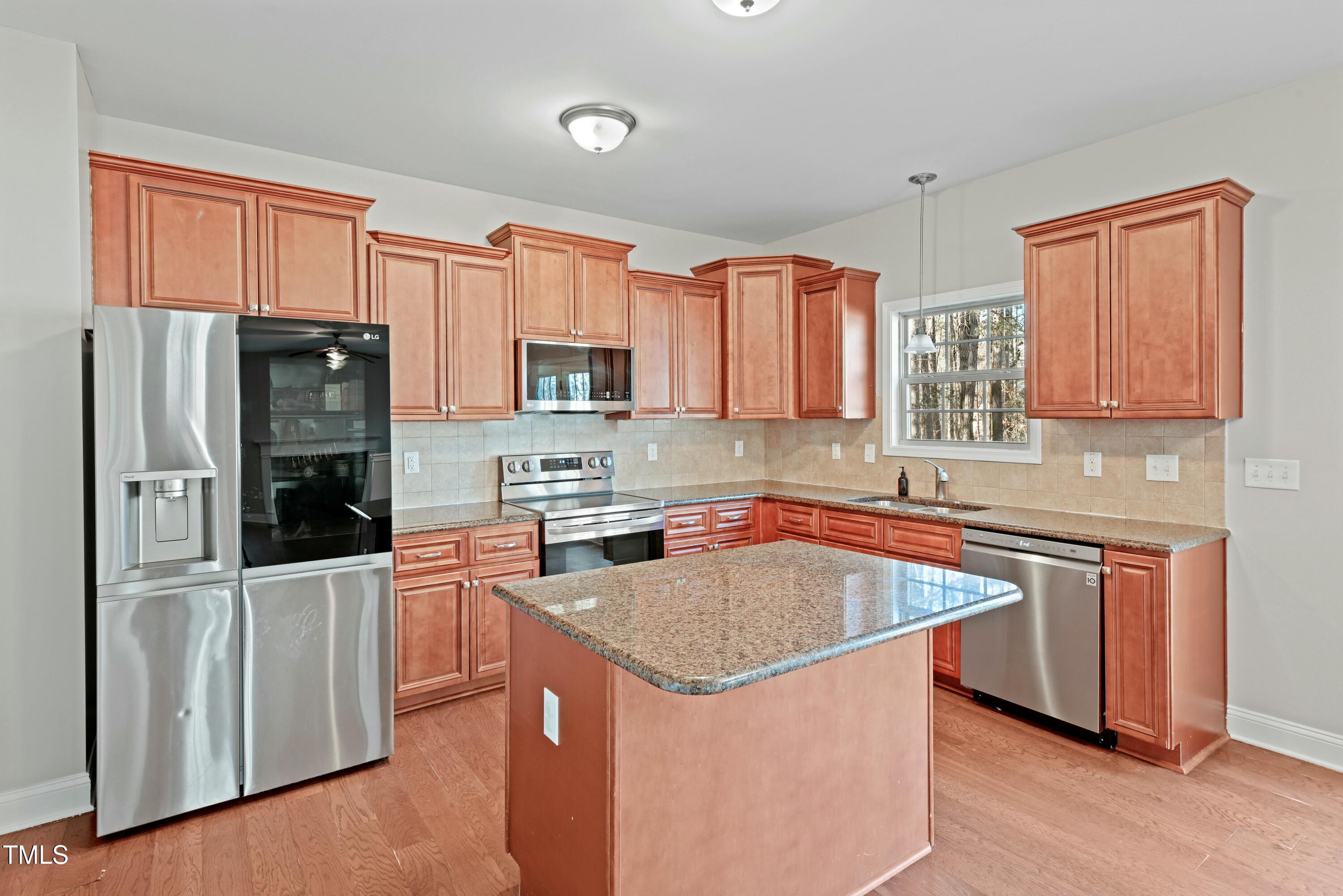 64 Valor Circle Bunnlevel, NC 28323 - Photo 12 of 34 a kitchen with stainless steel appliances granite countertop a refrigerator stove microwave and sink