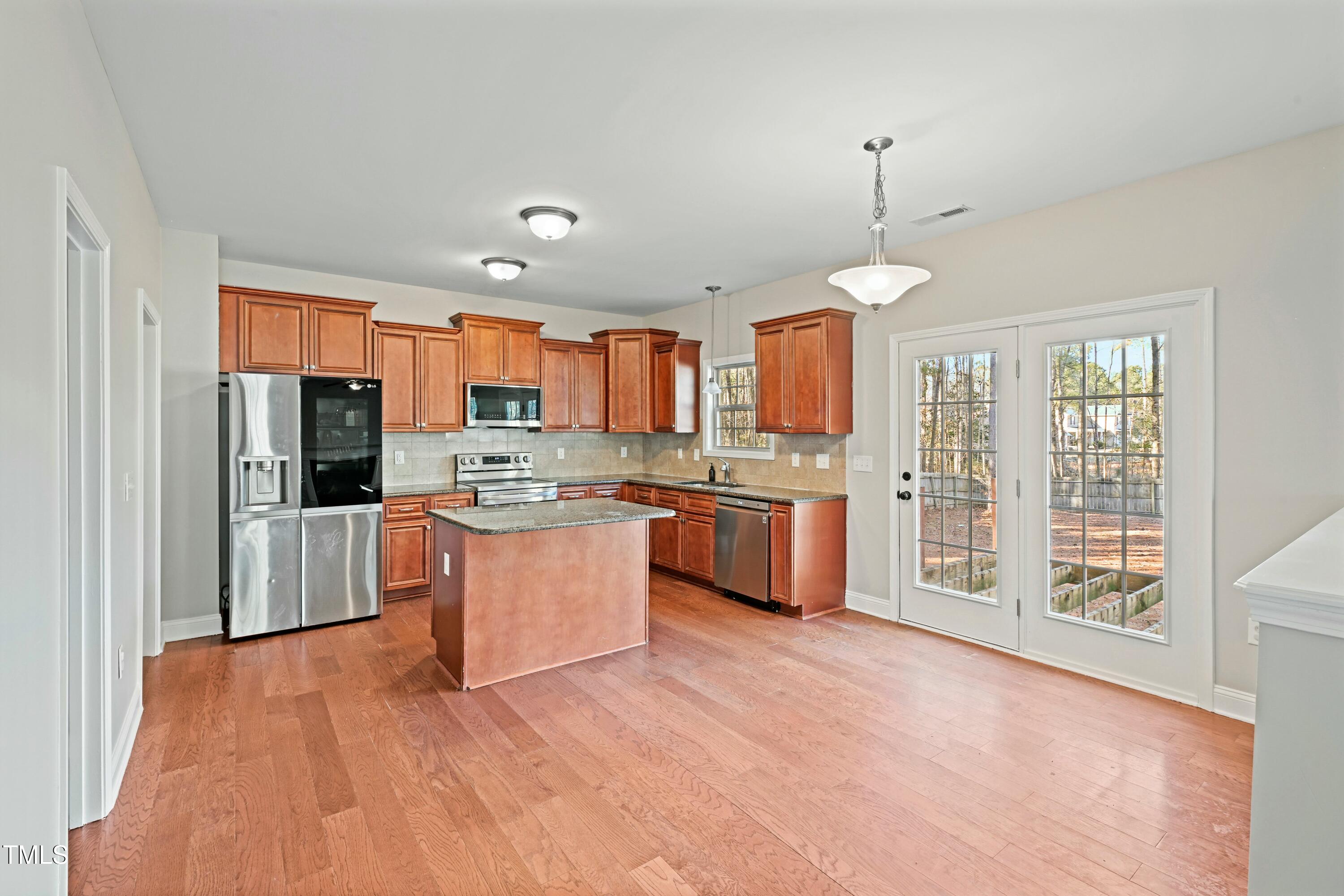 64 Valor Circle Bunnlevel, NC 28323 - Photo 14 of 34 a large kitchen with kitchen island a large counter top stainless steel appliances and cabinets