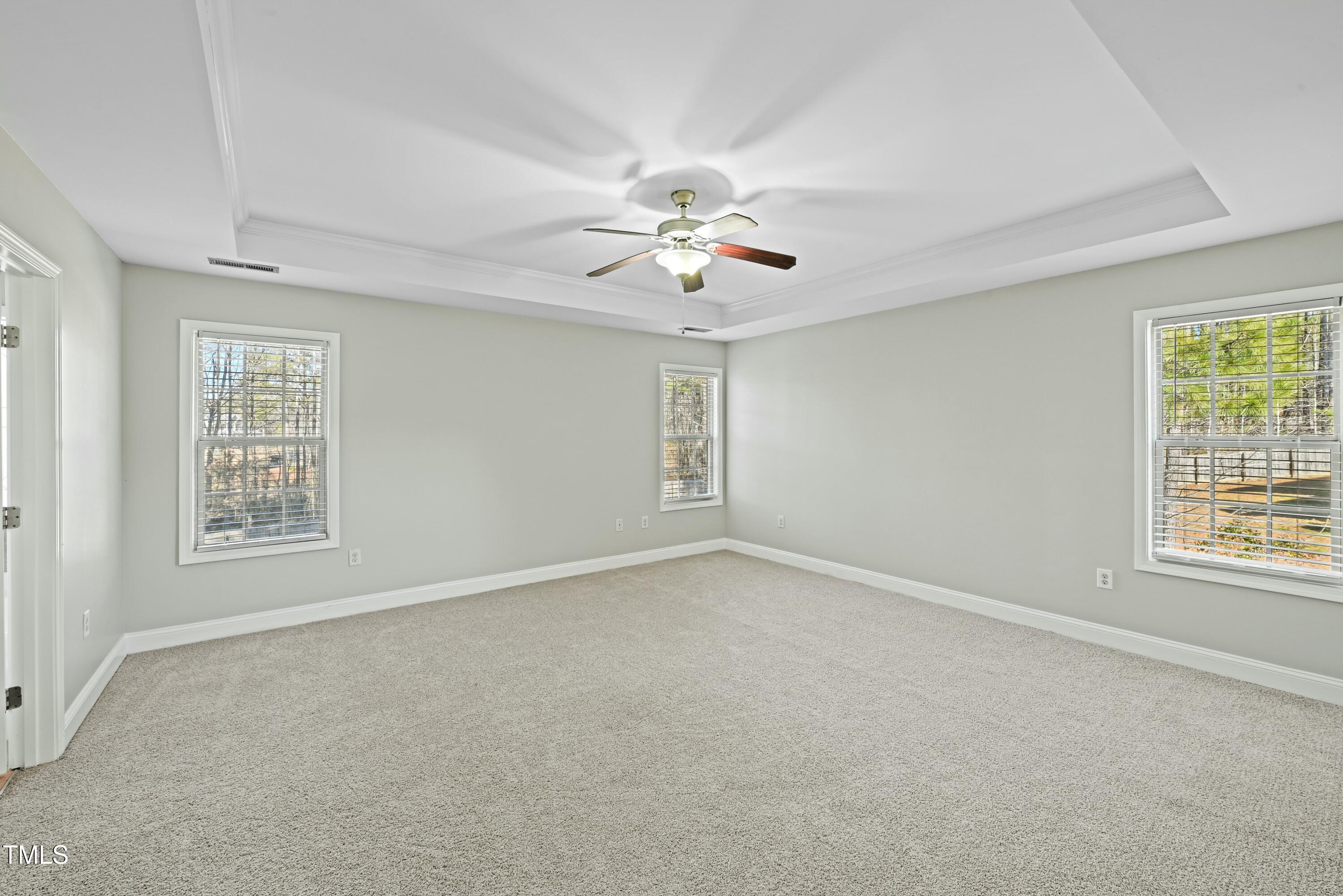 64 Valor Circle Bunnlevel, NC 28323 - Photo 17 of 34 an empty room with windows and ceiling fan