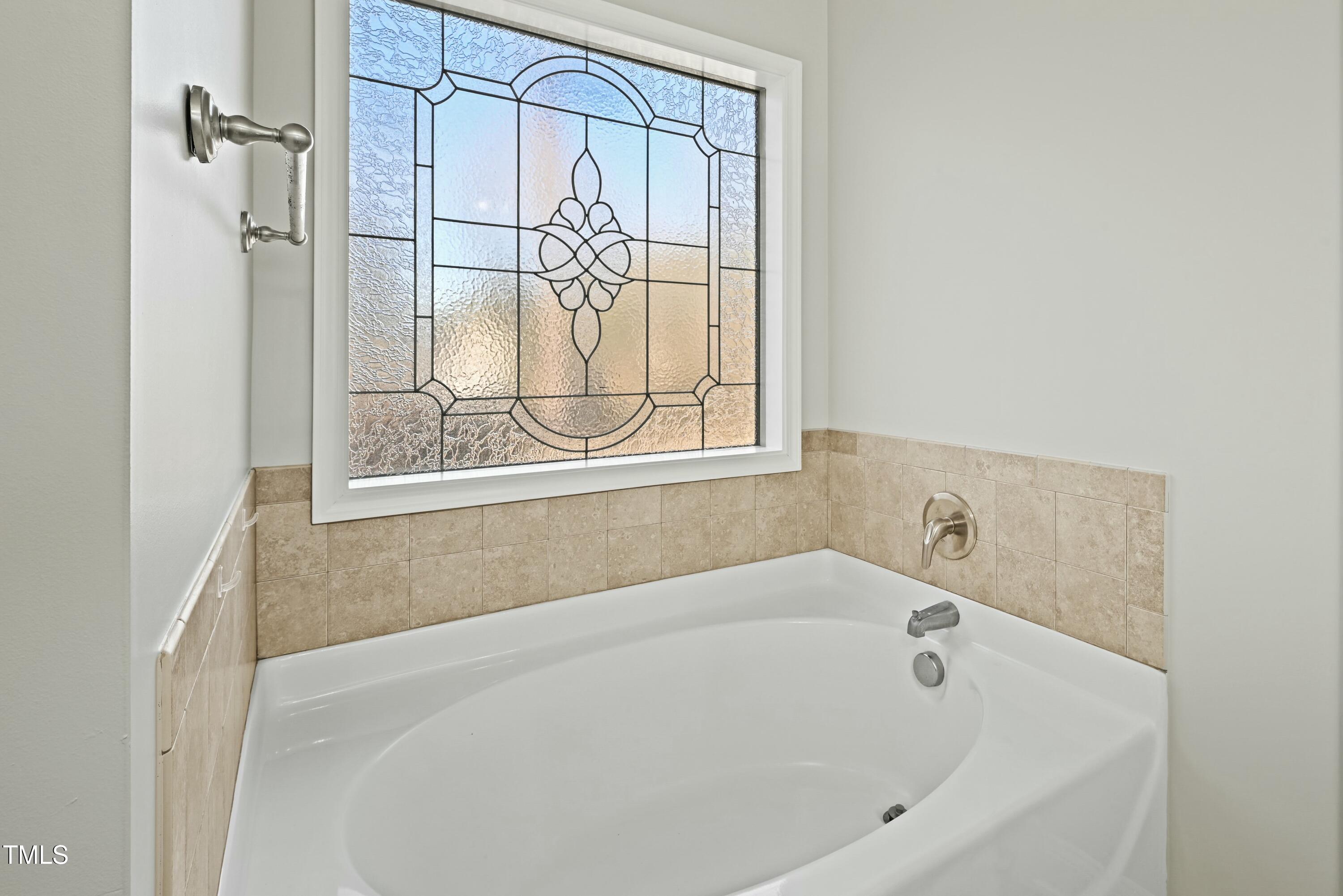 64 Valor Circle Bunnlevel, NC 28323 - Photo 21 of 34 a white bath tub sitting next to a window