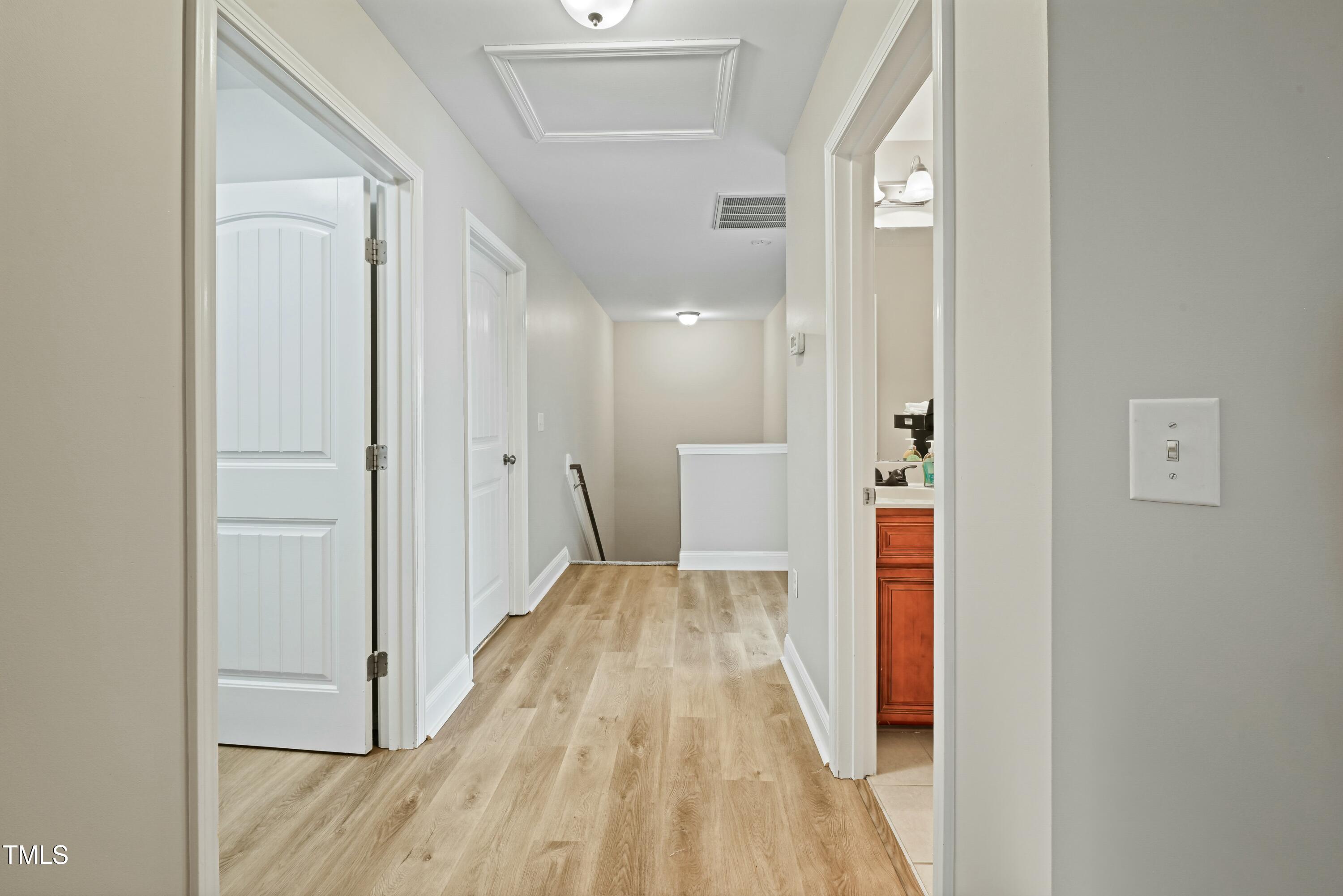 64 Valor Circle Bunnlevel, NC 28323 - Photo 27 of 34 a view of a hallway with wooden floor and a bathroom
