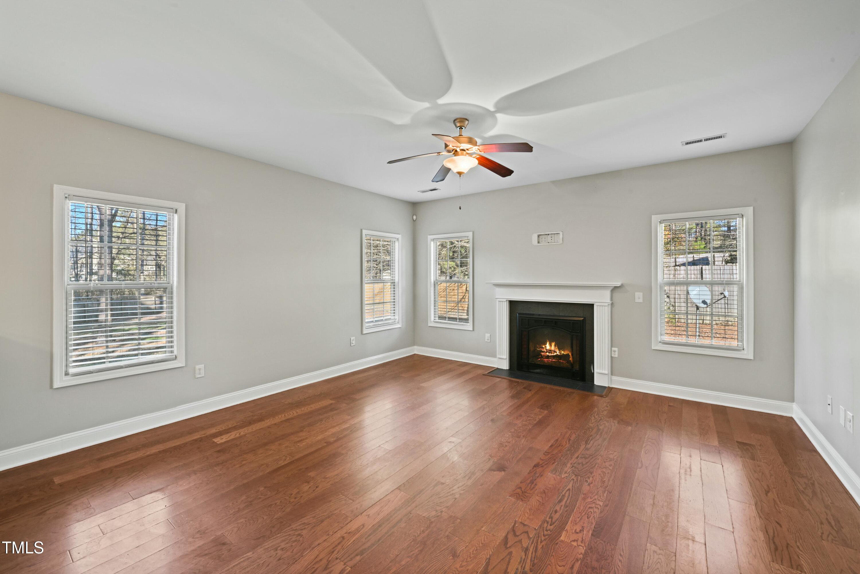 64 Valor Circle Bunnlevel, NC 28323 - Photo 7 of 34 a view of an empty room with wooden floor fireplace and a window