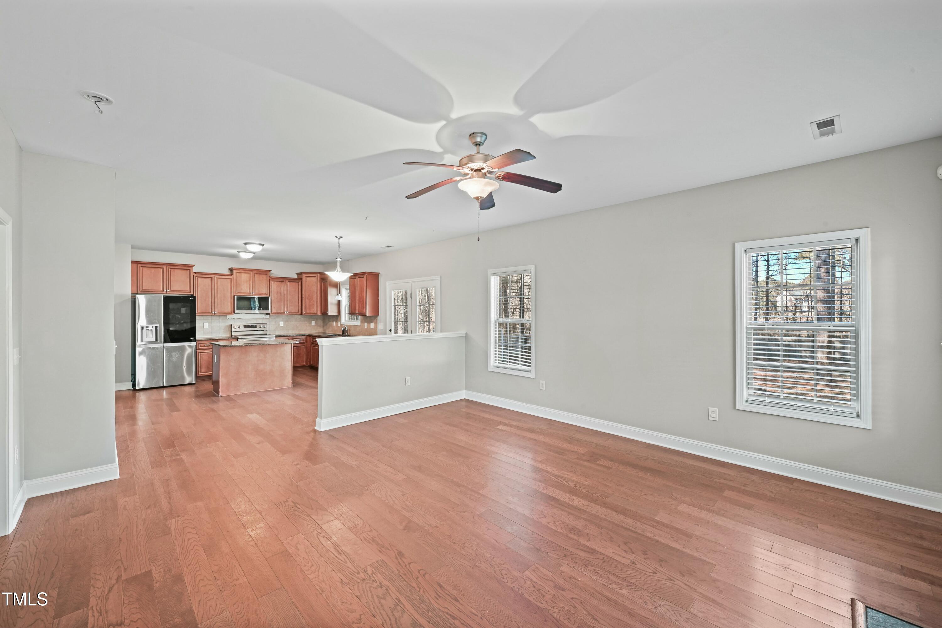 64 Valor Circle Bunnlevel, NC 28323 - Photo 8 of 34 a view of an empty room with a window and wooden floor