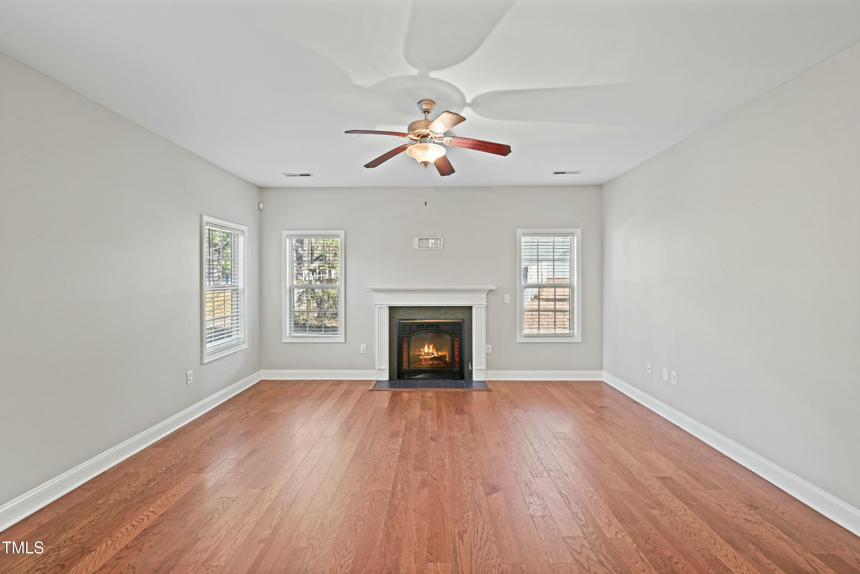 64 Valor Circle Bunnlevel, NC 28323 - Photo 9 of 34 a view of an empty room with wooden floor fireplace and a window