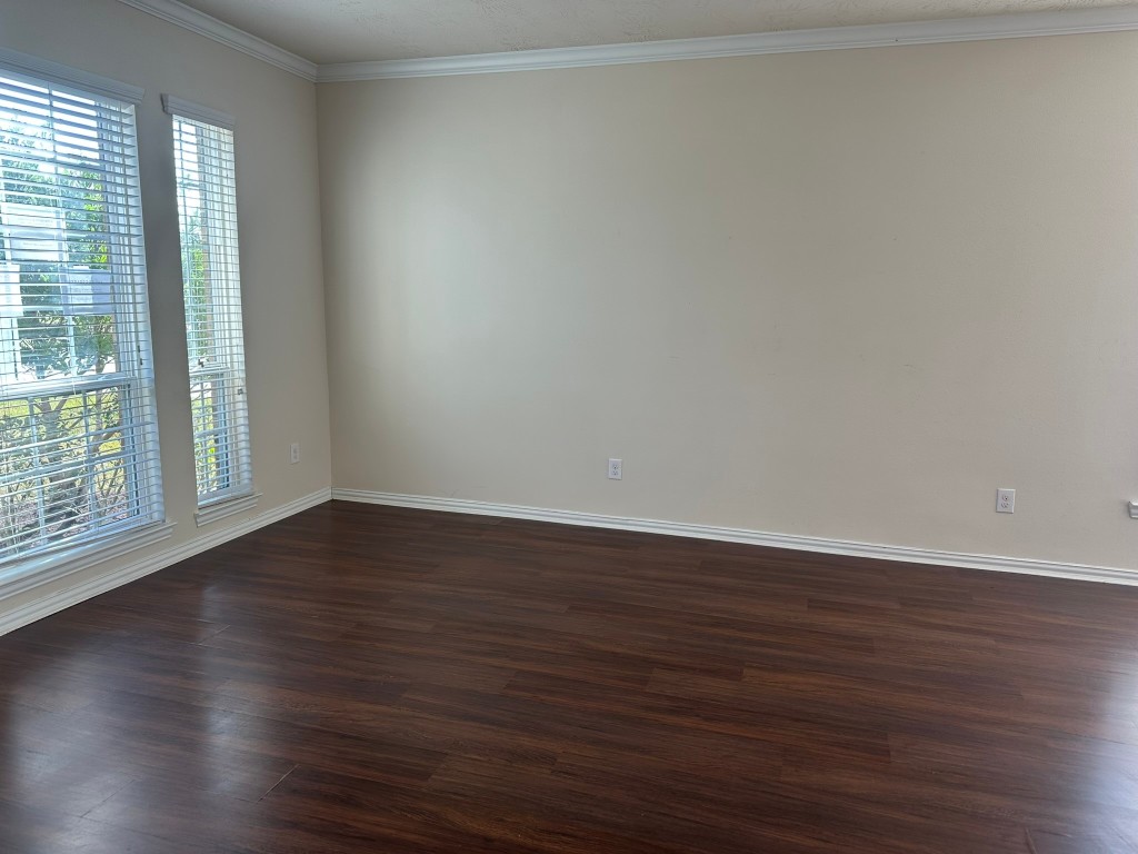 9914 Channel Set Way Rosharon, TX 77583 - Photo 3 of 24 a view of an empty room with wooden floor and a window