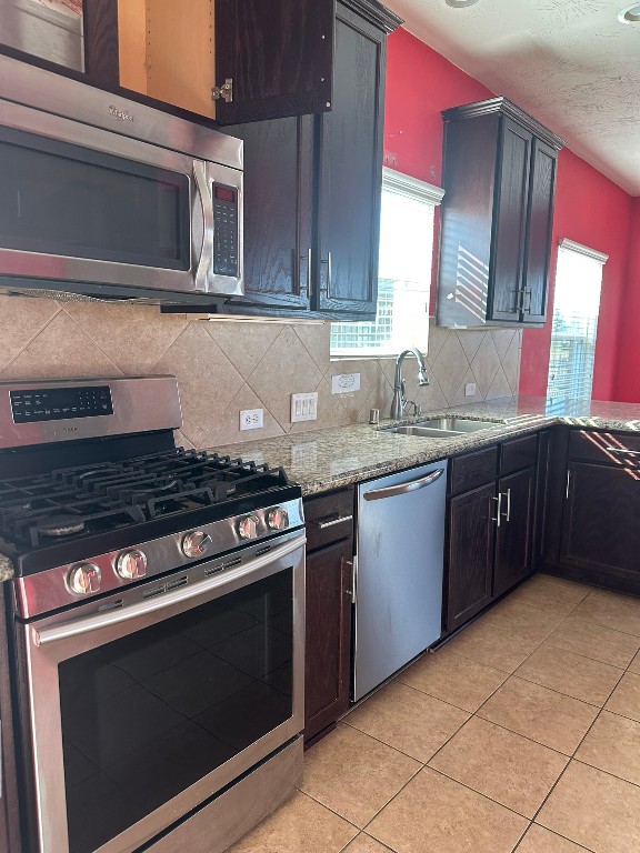 9914 Channel Set Way Rosharon, TX 77583 - Photo 6 of 24 a kitchen with stainless steel appliances granite countertop a stove microwave and sink