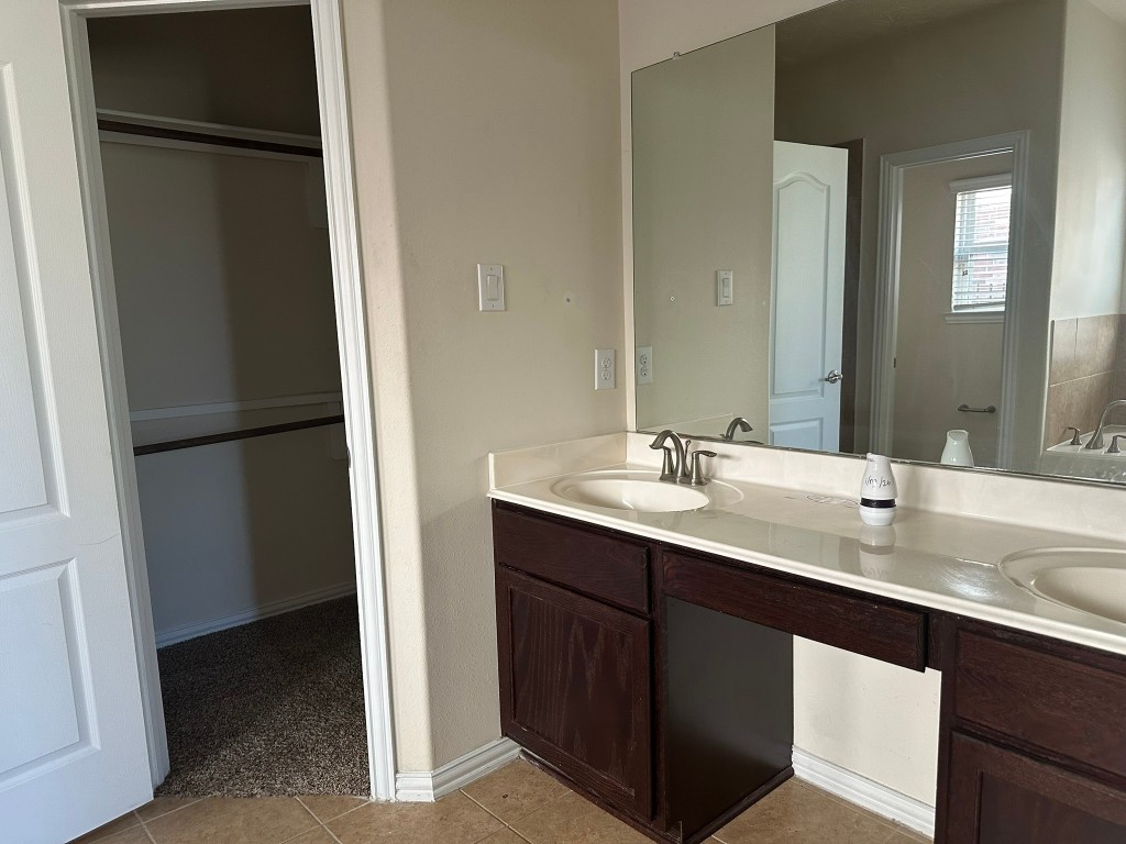 9914 Channel Set Way Rosharon, TX 77583 - Photo 10 of 24 a bathroom with a double vanity sink and mirror