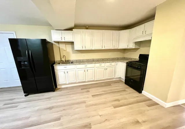 a kitchen with a refrigerator and a stove