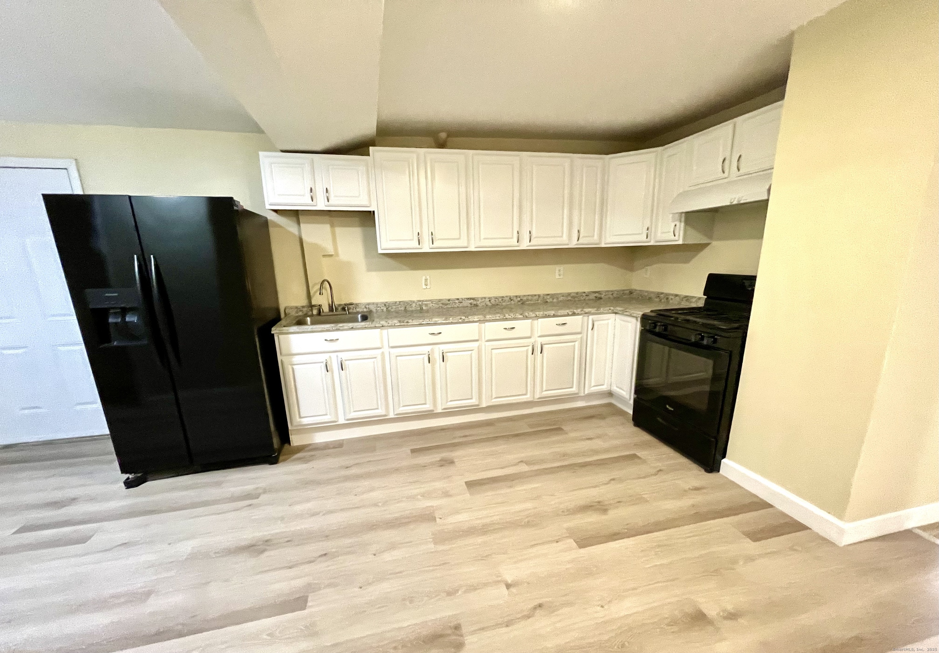 92 West Main Street, Unit 6 Vernon, CT 06066 - Photo 3 of 8 a kitchen with a refrigerator and a stove