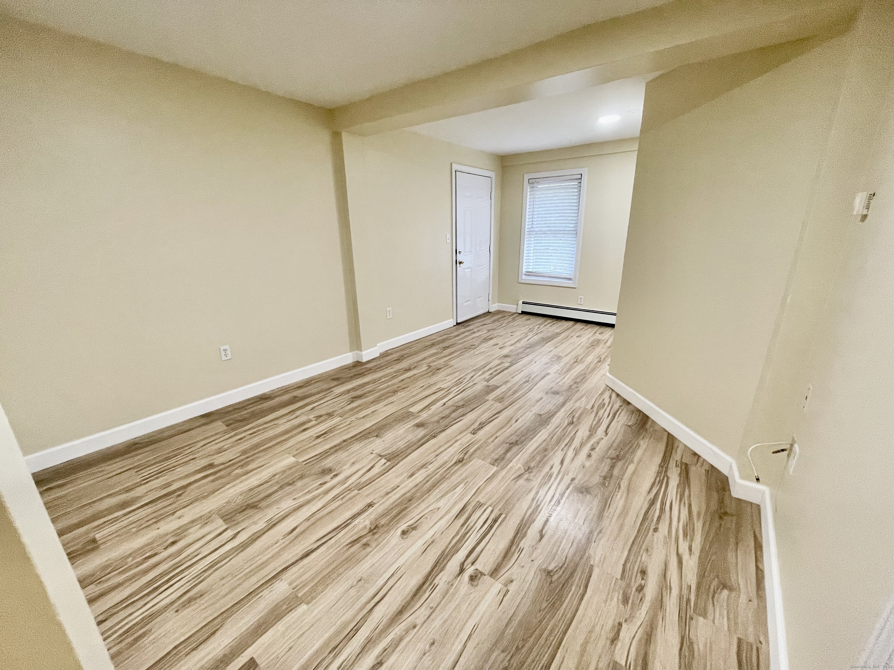 92 West Main Street, Unit 6 Vernon, CT 06066 - Photo 4 of 8 a view of a room with wooden floor and bench