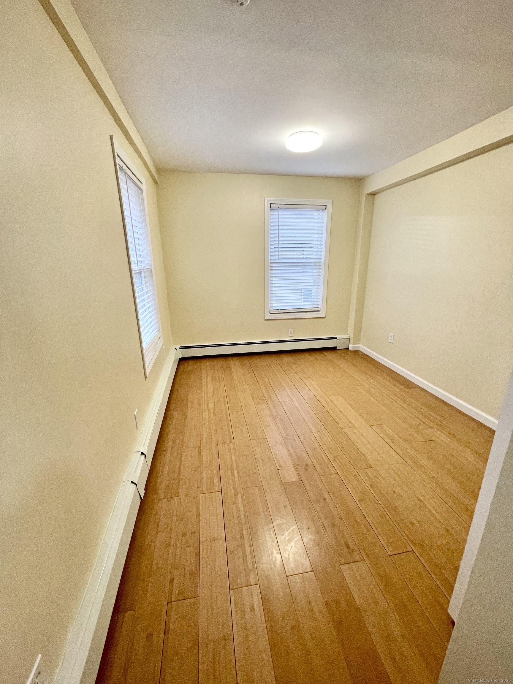 92 West Main Street, Unit 6 Vernon, CT 06066 - Photo 7 of 8 a view of an empty room with wooden floor and a window