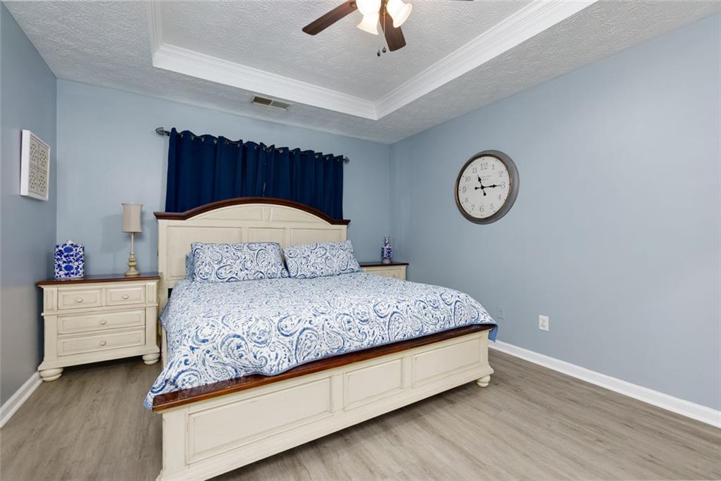 67 Granite Court Dallas, GA 30132 - Photo 14 of 27 a bedroom with a bed and a chandelier