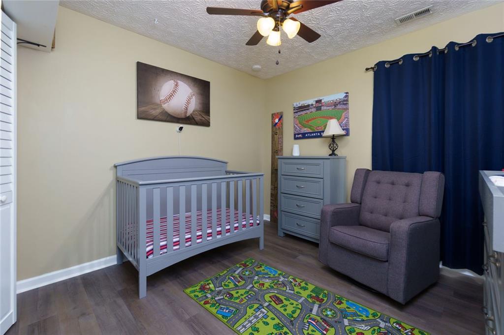 67 Granite Court Dallas, GA 30132 - Photo 19 of 27 a living room with furniture and a baby crib