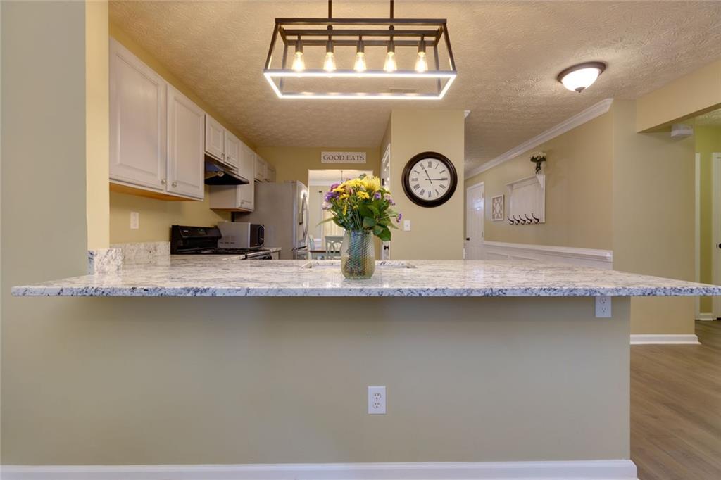 67 Granite Court Dallas, GA 30132 - Photo 8 of 27 a kitchen with a stove a clock and cabinets
