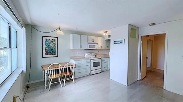 a kitchen with stainless steel appliances a stove a sink and a refrigerator