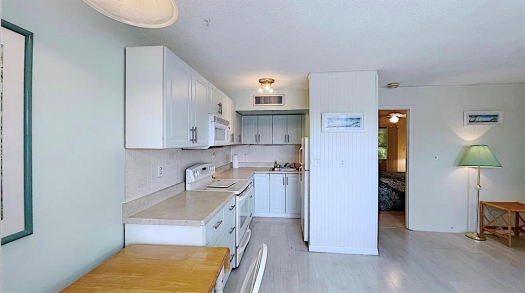 1200 Colonnades Drive, Unit 208 Fort Pierce, FL 34949 - Photo 13 of 31 a kitchen with a sink cabinets and counter space