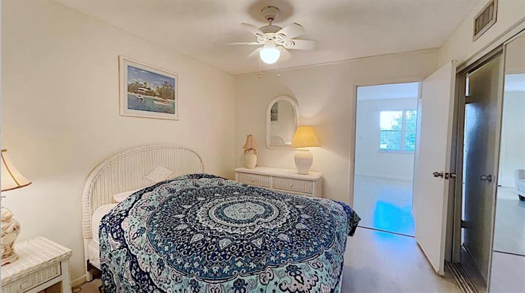1200 Colonnades Drive, Unit 208 Fort Pierce, FL 34949 - Photo 15 of 31 a bedroom with a bed dresser and a window