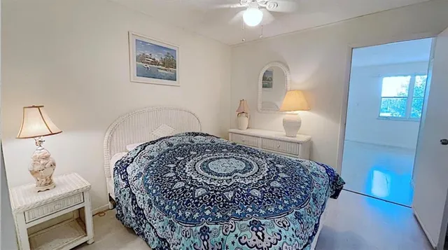 a bedroom with a bed and a lamp with the dresser