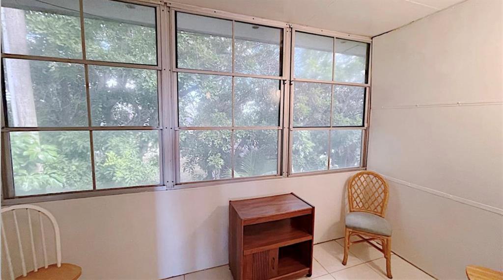 1200 Colonnades Drive, Unit 208 Fort Pierce, FL 34949 - Photo 18 of 31 a view of a chair and table in a room