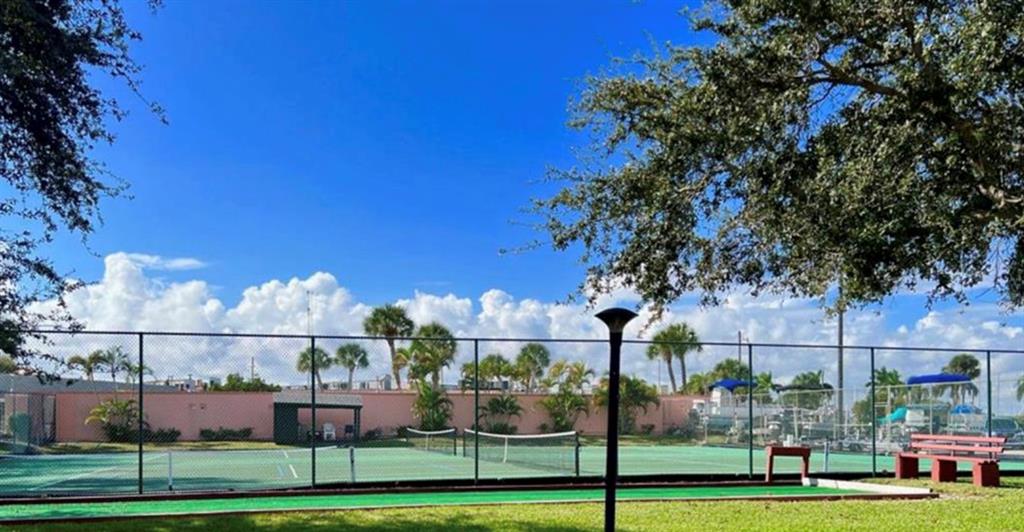 1200 Colonnades Drive, Unit 208 Fort Pierce, FL 34949 - Photo 30 of 31 a view of a big yard and large trees