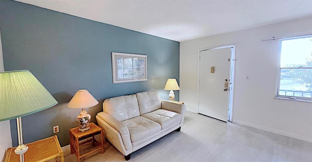 1200 Colonnades Drive, Unit 208 Fort Pierce, FL 34949 - Photo 4 of 31 a living room with furniture and a window