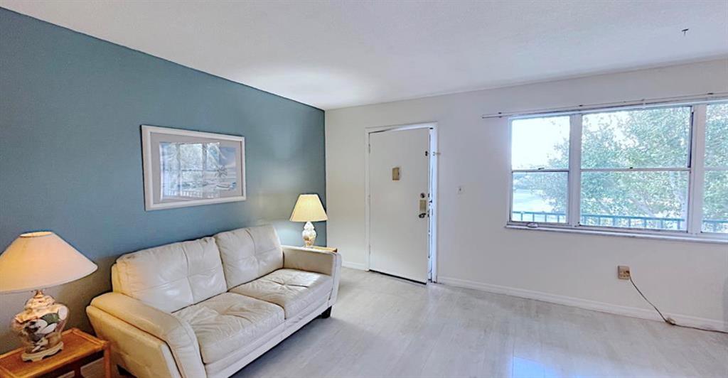 1200 Colonnades Drive, Unit 208 Fort Pierce, FL 34949 - Photo 5 of 31 a living room with furniture and a window