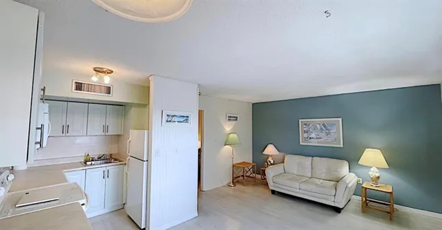 a living room with furniture a lamp and a chandelier